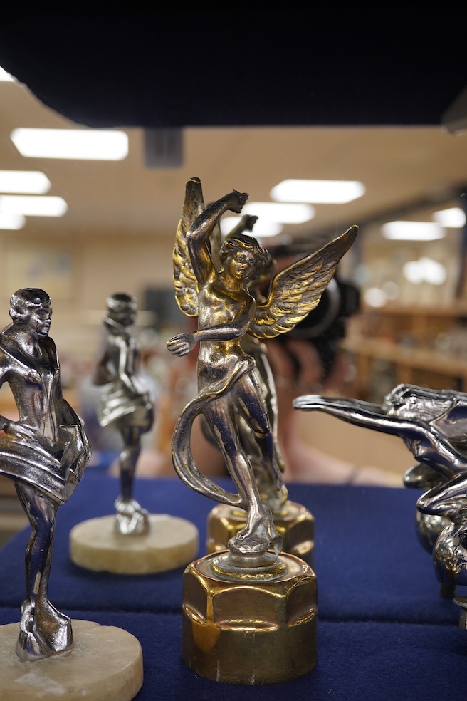 Five chrome car mascots in the form of female dancing figures, three mounted on threaded radiator caps, one with a registration number: 675619, one a stylised Art Deco winged female figure astride a globe. Condition - fa
